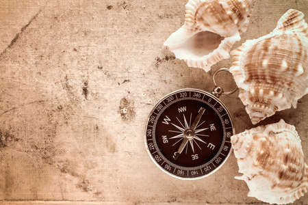 Compass and sea shells on old canvas with copy-spaceの写真素材