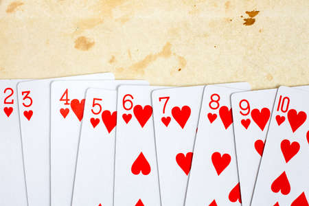 Hearts playing cards set on old paper backgroundの写真素材