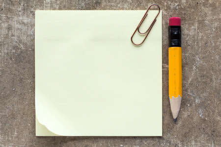 Sticky note paper with paperclip and pencilの写真素材