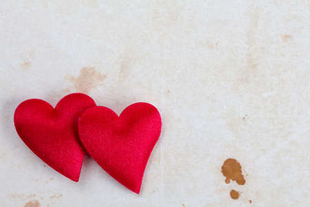 Two decorative hearts on stained paper with copy-spaceの写真素材