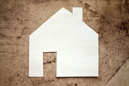 Paper house icon on dirty canvas backgroundの写真素材