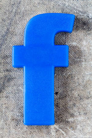 Blue plastic letter F on grunge background