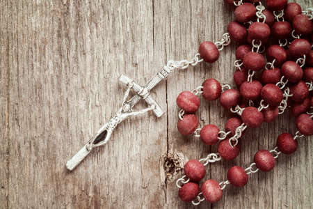 Silver cross crucifix on old wooden backgroundの写真素材