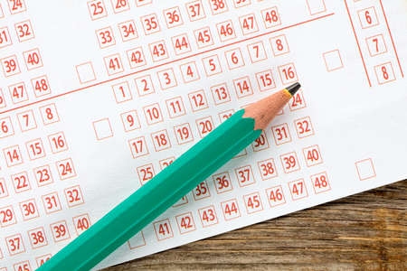 Closeup of lottery ticket and green pencilの写真素材