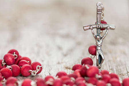 Catholic rosary on old wooden  background. Selective focus.の写真素材