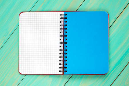 Open spiral notebook on the wooden background.Top view.の写真素材
