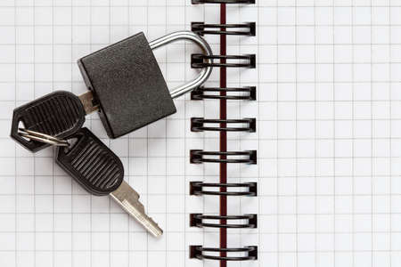 Open notebook with a padlock and keys, text spaceの写真素材