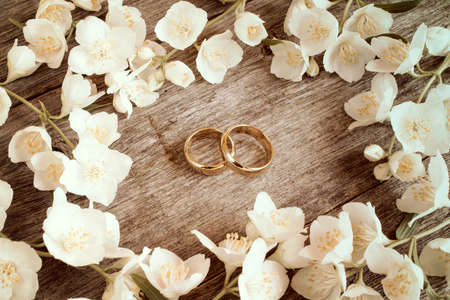 Wedding rings in a middle of white summer flowersの写真素材