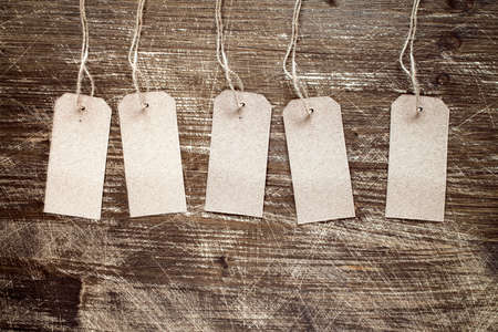 blank tags on the wooden background with copy-spaceの写真素材