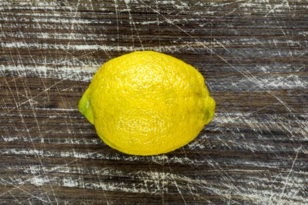 Fresh yellow lemon on the wooden backgroundの写真素材