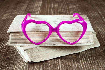 Love to read concept with books and heart shaped glassesの写真素材