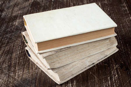 Vintage old books on wooden deck tabletopの写真素材