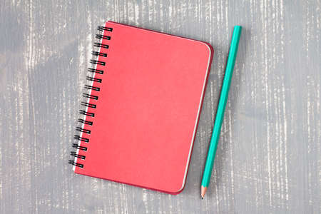 Spiral notebook and pencil over grey wooden background.Copy-space.の写真素材
