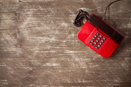 Top view of old fashioned telephone on wooden background with copy-spaceの写真素材