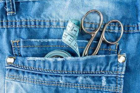 Close up of jeans pocket with fashion designer tools