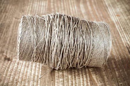 Skein jute twine on old wooden table background