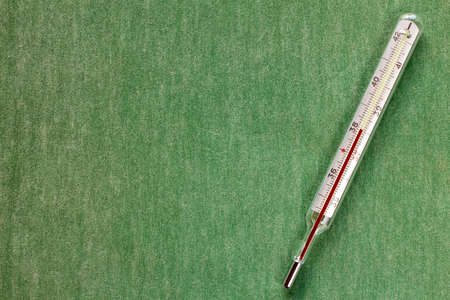 Thermometer showing high body temperature.Cpy space.の写真素材