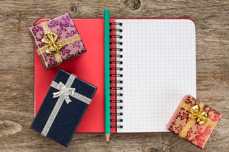 Personal organizer and gift boxes on the wooden background