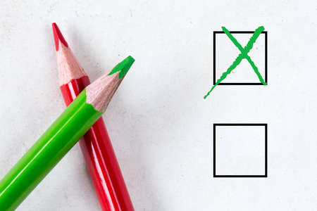 Green and red pencils with marking checkbox. Concept for customer satisfaction survey,education research or electionの写真素材