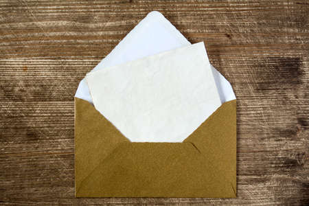 Golden envelope with blank letter for your messageの写真素材