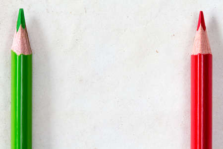 Green and red pencils with copy-space on paper backgroundの写真素材