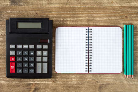 Old calculator,open notebook and four pencils.Top view.の写真素材