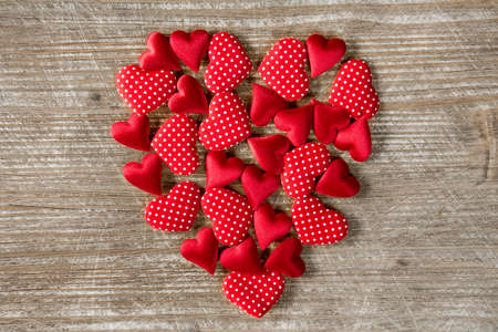 Heart shape formed with small hearts on wooden background. Love concept. Valentine's Day concept.の写真素材