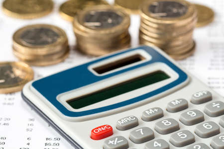 Close-up of calculator on financial statement with Euro coins, concept of accountsの写真素材