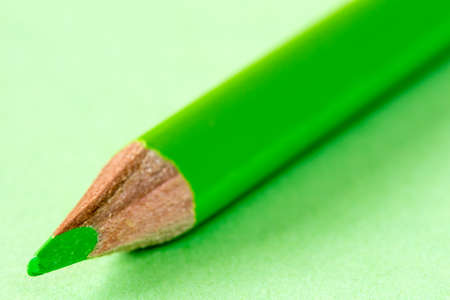 Close-up view of green pencil on paper background. Business or education concept.の写真素材