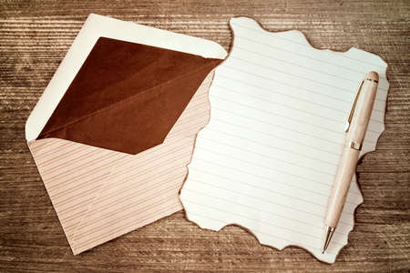 Open envelope with blank burned letter on wooden backgroundの写真素材