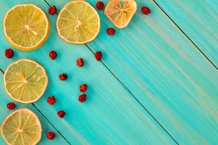 Dried oranges with ashberry on the white wooden background.の写真素材