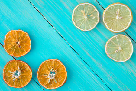 Dried slices of citrus fruits on the blue wooden backgroundの写真素材