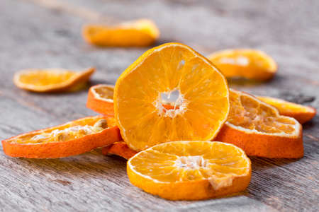 Slices of dried orange on the wooden backgroundの写真素材