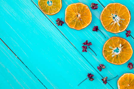  Orange slices and dry herbs on the blue wooden background.の写真素材