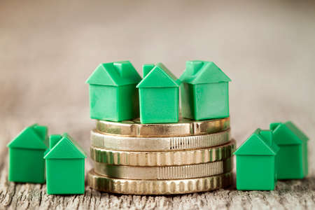 Real estate mortgage concept with green houses and coinsの写真素材