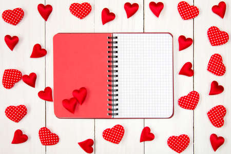 Valentine hearts with open blank notebook on wooden backgroundの写真素材