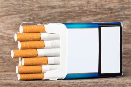 Open pack of cigarettes with cigarettes sticking outの写真素材