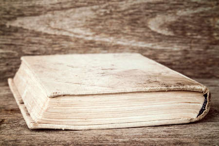 The old book lies on wooden backgroundの写真素材
