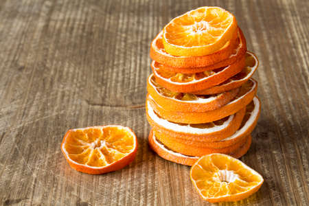 Stack from slices of orange fruit on the wooden backgroundの写真素材