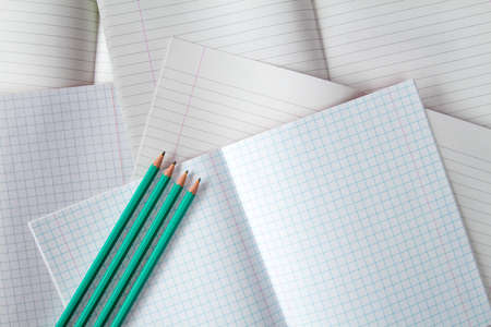 Various exercise books and four pencils. Education concept.の写真素材