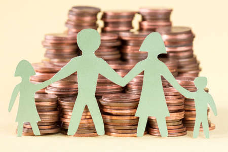 Paper family and huge pile of coins.Investments and people concept.の写真素材