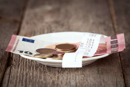 Plate with bill,money and tips. Selective focus.の写真素材