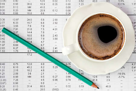 Coffee cup on financial highlight page ,concept of paperworkの写真素材