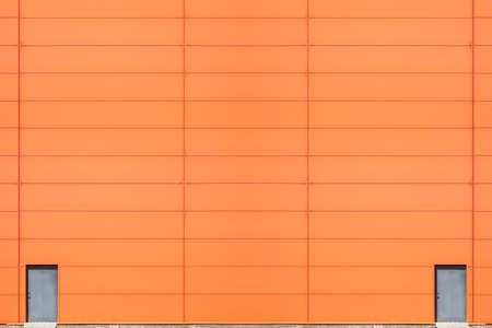 Modern industrial building wall with metal doorsの写真素材