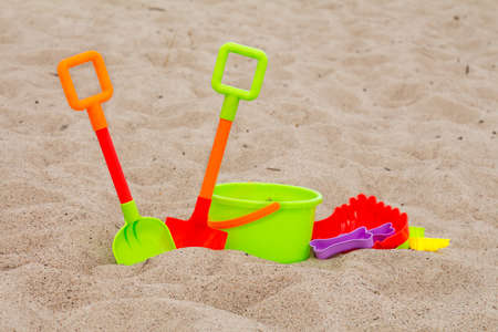 Vacation image of children's beach toys on the sandの写真素材