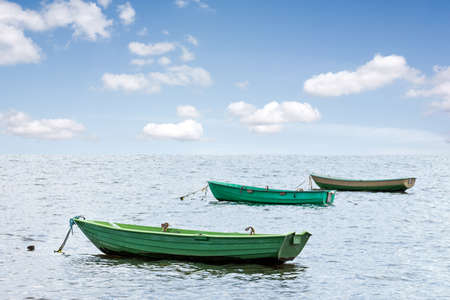 Three wooden boats floating out to seaの写真素材