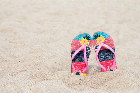 Flip flop on the sand beach in summer vacations. Copy-space.の写真素材
