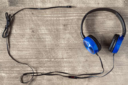 Blue headphones on wooden background with copy-spaceの写真素材