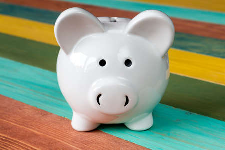 Piggy bank on color wooden background, close-up viewの写真素材