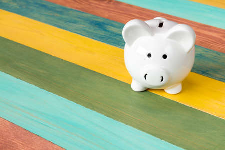 Piggy bank on color wooden background,financial investment or saving conceptの写真素材